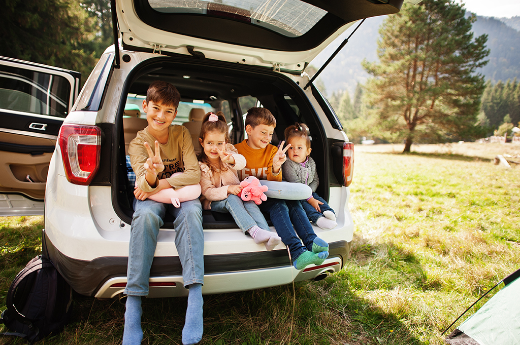 family-of-four-kids-at-vehicle-interior-children-sitting-in