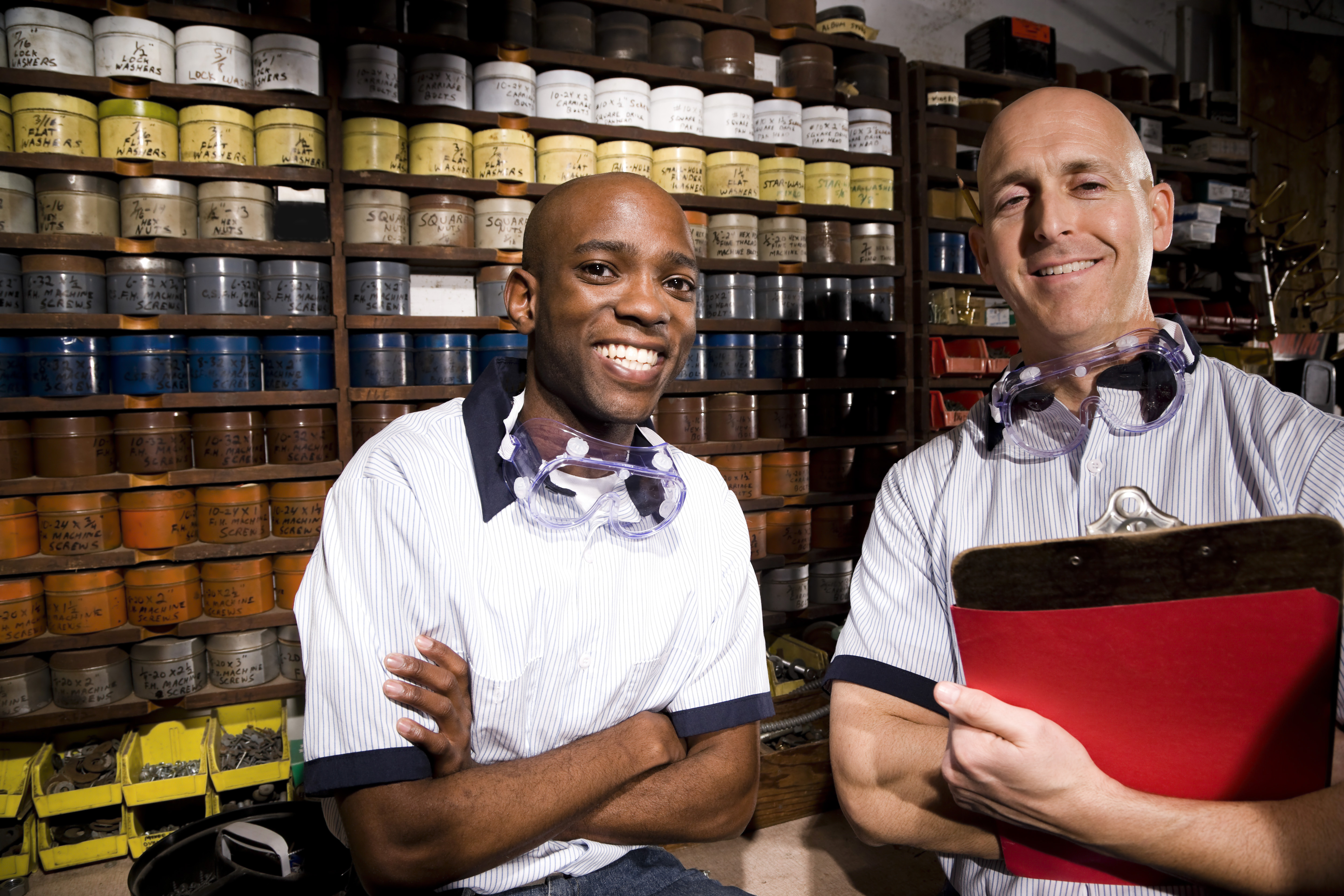 Two male multi ethnic workers working in printing shop